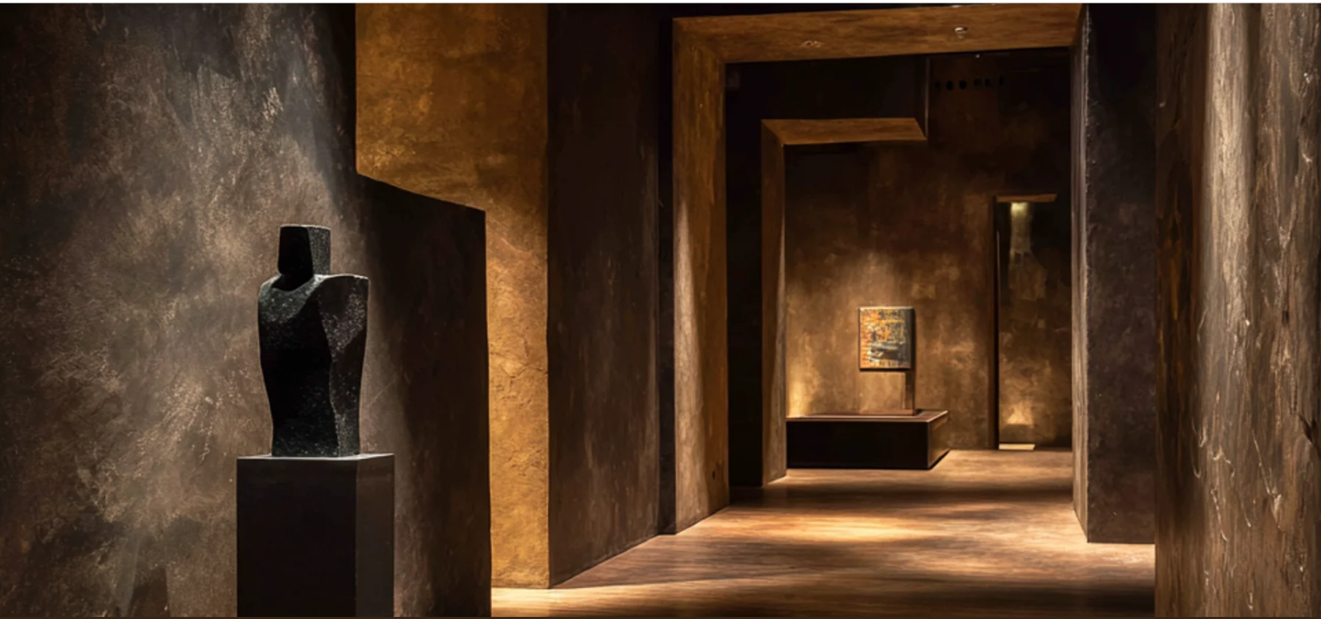 The warm bronze and dark-stone interior hallway of The Umber Throne Gallery